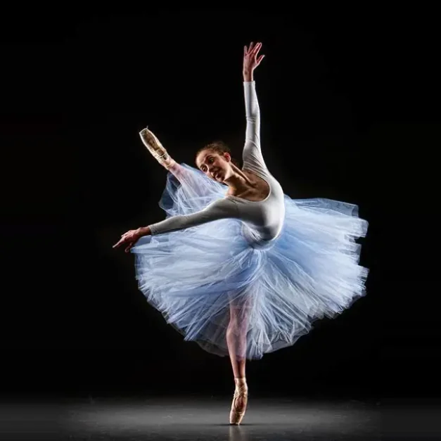 Ballet dancer in a dramatic penché on stage