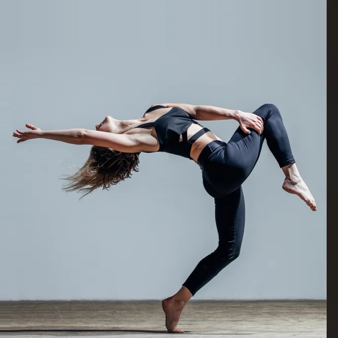 Contemporary dancer in a dynamic backbend pose