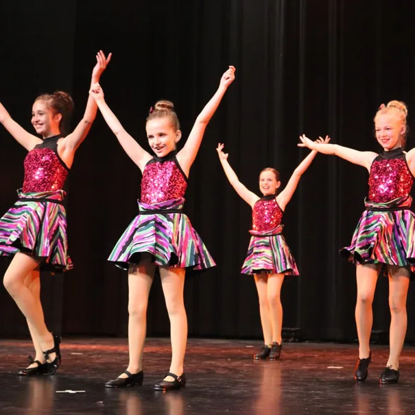 Junior tap dancers performing on stage